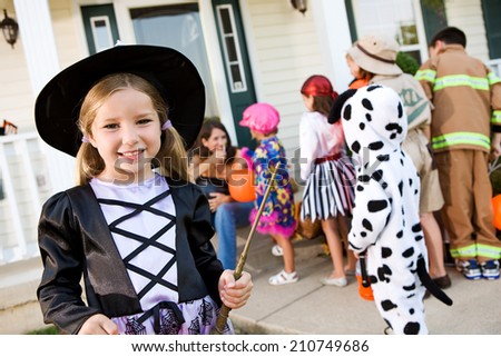 Halloween: Smiling Girl Witch Going Trick Or Treating With Friends