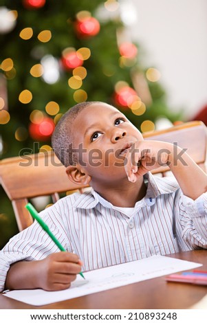 Christmas: Cute Boy Sitting And Writing Letter To Santa