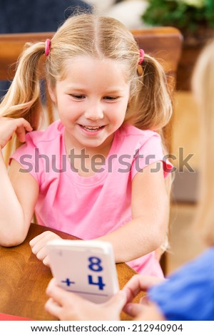 Student: Smiling Girl Practicing Math With Flash Cards