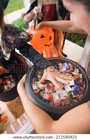 Halloween: Kids Reaching In For Trick Or Treat Candy