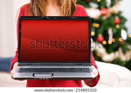 Christmas: Anonymous Woman Holding Up Laptop With Blank Festive Screen