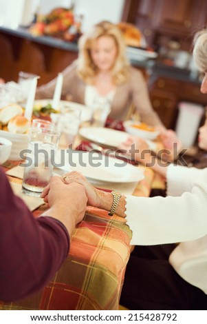 Thanksgiving: Family Praying Before Holiday Dinner