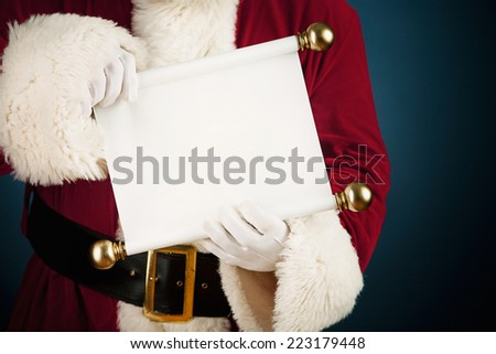Santa Claus: Holding Out Blank Paper Scroll To Camera