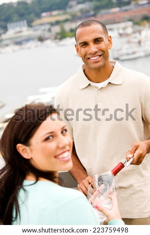 Wine: Smiling Man Uncorks Wine For Friend