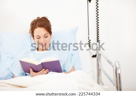 Hospital: Female Patient Reads In Bed