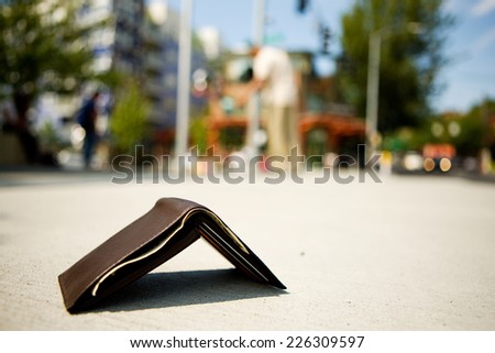 Man Looking For Wallet Laying On Sidewalk