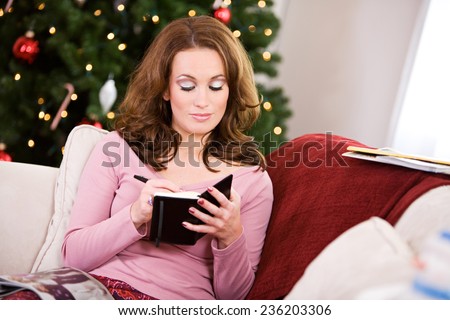 Christmas: Woman Checking Schedule In Date Book