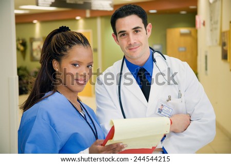 Hospital: Smiling Doctor And Nurse In Hospital Lobby