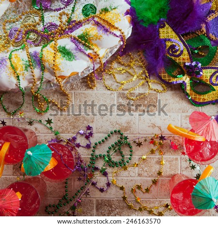 Mardi Gras: Overhead Of King Cake, Mask And Tropical Hurricane Cocktails