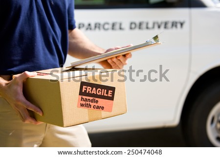 Delivery: Focus on Cardboard Box with Label