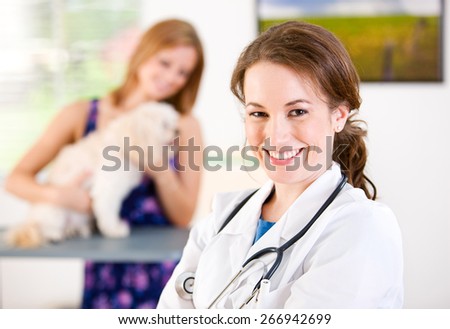 Veterinarian: Cheerful Female Veterinarian With Owner And Pet