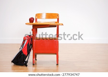 School: Empty School Desk With Apple And Backpack