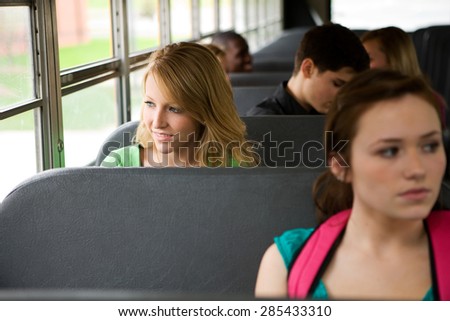 School Bus: Cheerful Girl Riding School Bus Looking Out Window