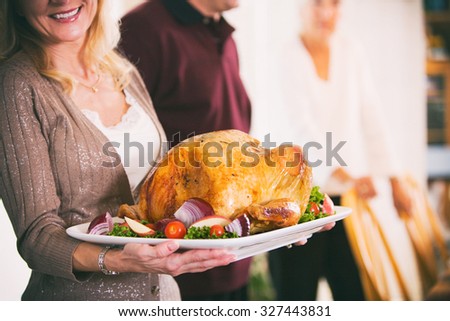 Thanksgiving: Woman Holding Platter With Roast Turkey And Garnish