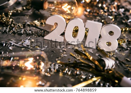 Image from a series celebrating New Year's Eve, some with 2018 numerals.  Lots of confetti, champagne, etc. Good for backgrounds of ads.