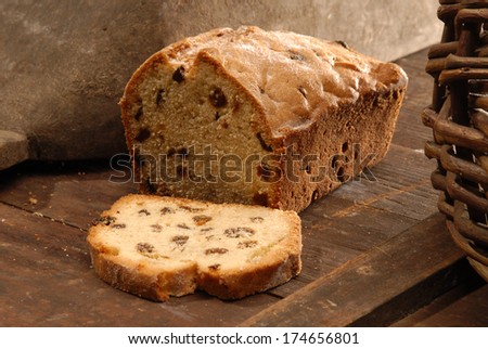 Bread With Raisins And Sugar Powder On The Dark Wooden Surface