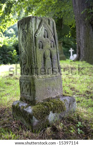 Decorated Anglo-Saxon stone cross in graveyard