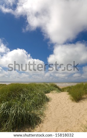Sunny summer day beach scene with dunes and sandy path to beach - Ainsdale on Sea, Sefton Coast, UK