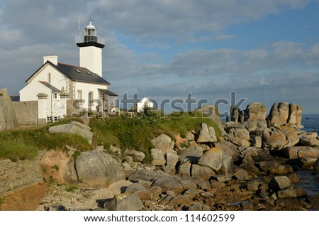 lighthouse on rocks surrounded by giant stones