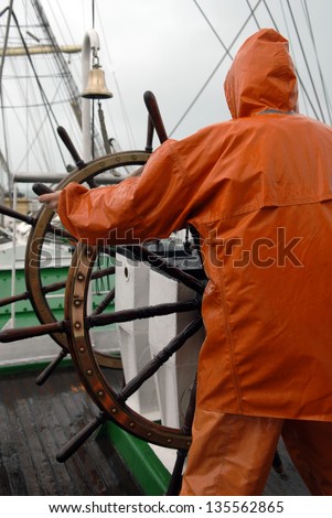 The captain at the helm of the ship