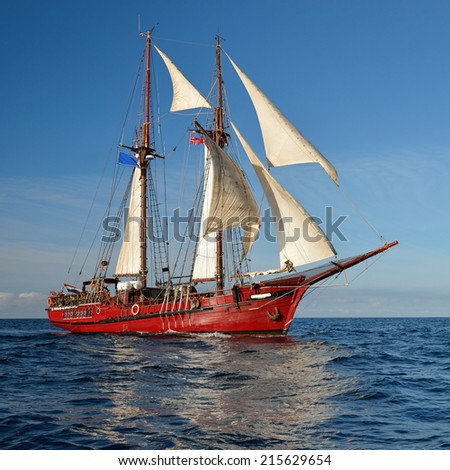 Sailing ship on the background of the beautiful sky and sea