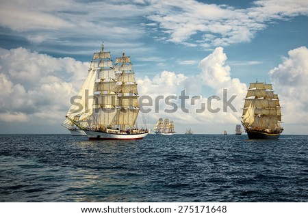 Sailing ships on a background of beautiful sky and sea