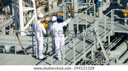 Oil And Gas Industry. Work on the gas tanker safety monitor. industrial. Workers on gas tankers