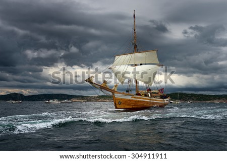 Vintage sailing ship in the beautiful stormy sky. Tall ship. Yachting. Sailing.