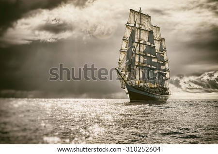 Sailing ship and a beautiful sky storm.  Toned image and blur. Retro style postcard. Sailing. Yachting. Travel