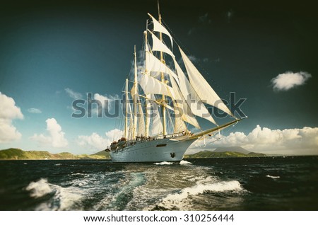 Sailing ship and beautiful wave.  Toned image and blur. Retro style postcard. Sailing. Yachting.
