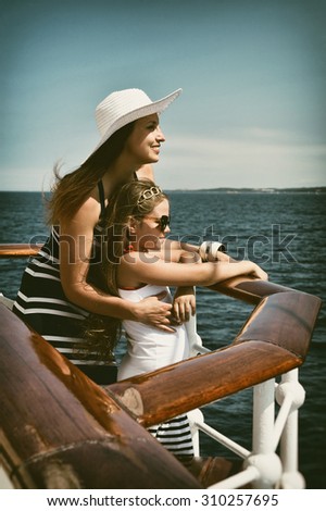 Yachting. Happy family on a cruise ship. Toned image and blur. Retro style postcard. Sailing. Travel