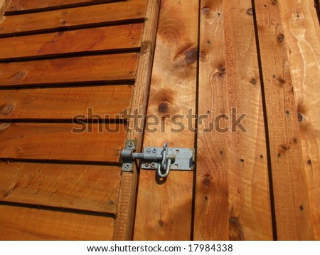 Metal Latch on Wooden Door of Garden shed with side view of panel