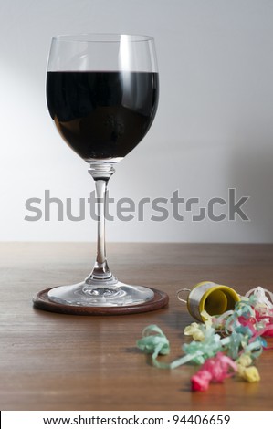 Glass of red wine and party popper