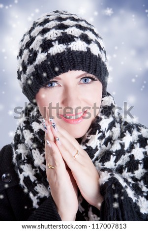 Beautiful woman in black and white winter clothes