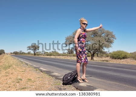 Attractive woman hitchhiking in Africa