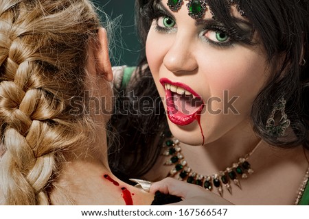 Thirsty vampire feeding on her victim