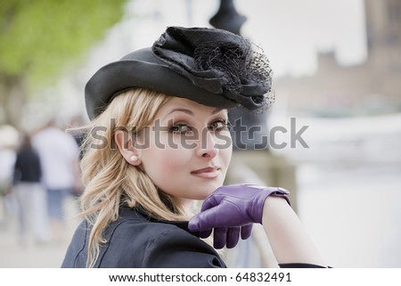 Elegant woman wearing  hat and gloves