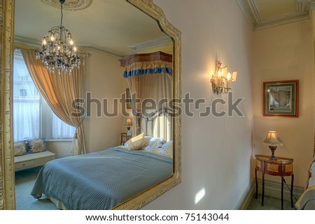 Luxurious bedroom reflected in a mirror