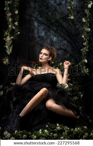 Beautiful woman surrounded by flowers and quirky environment