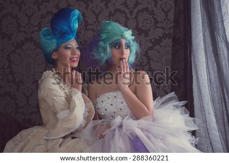 Two women in prom or historical dresses