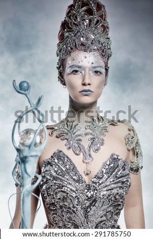 Beautiful winter witch in silver dress