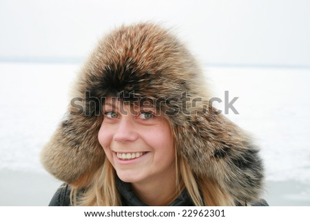 portrait of girl is in a fur cap