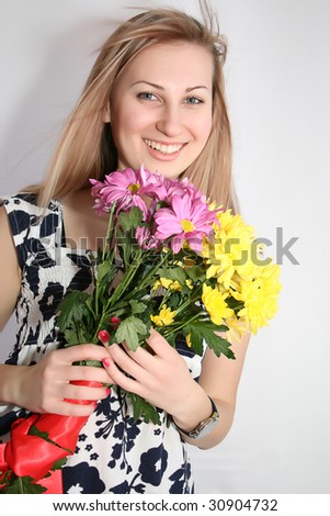 Happy young smiling woman with bunch of flowers
