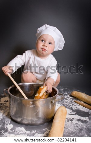Little boy cook with kitchen accessories and hat