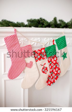 Christmas socks with gifts on the fireplace