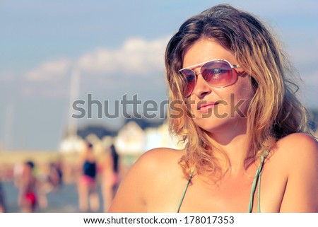 Beautiful girl natural looking retro colors portrait outdoor enjoying  the sun by the sea - Young woman fashion shoot by the sea