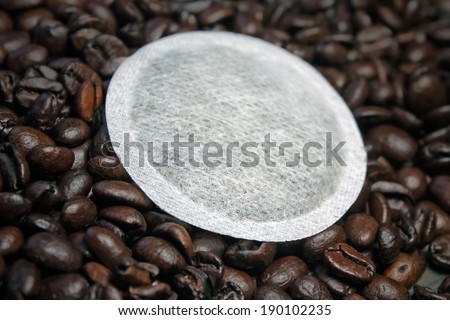 Coffee pods on coffee beans product background - Coffee pods modern filter coffee replacement on coffee beans