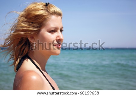 Beautiful self-confident woman on the beach