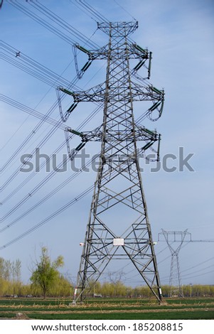 High voltage electricity pylon over blue sky