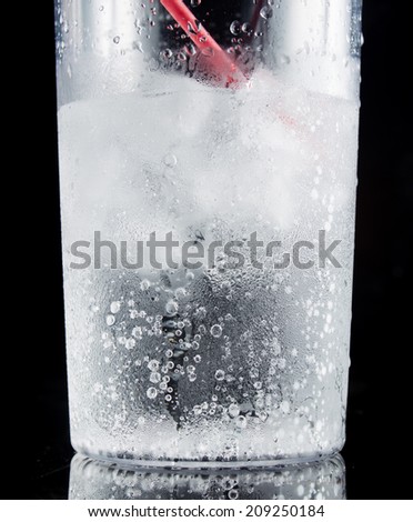 ice and soda in a glass cup - closeup